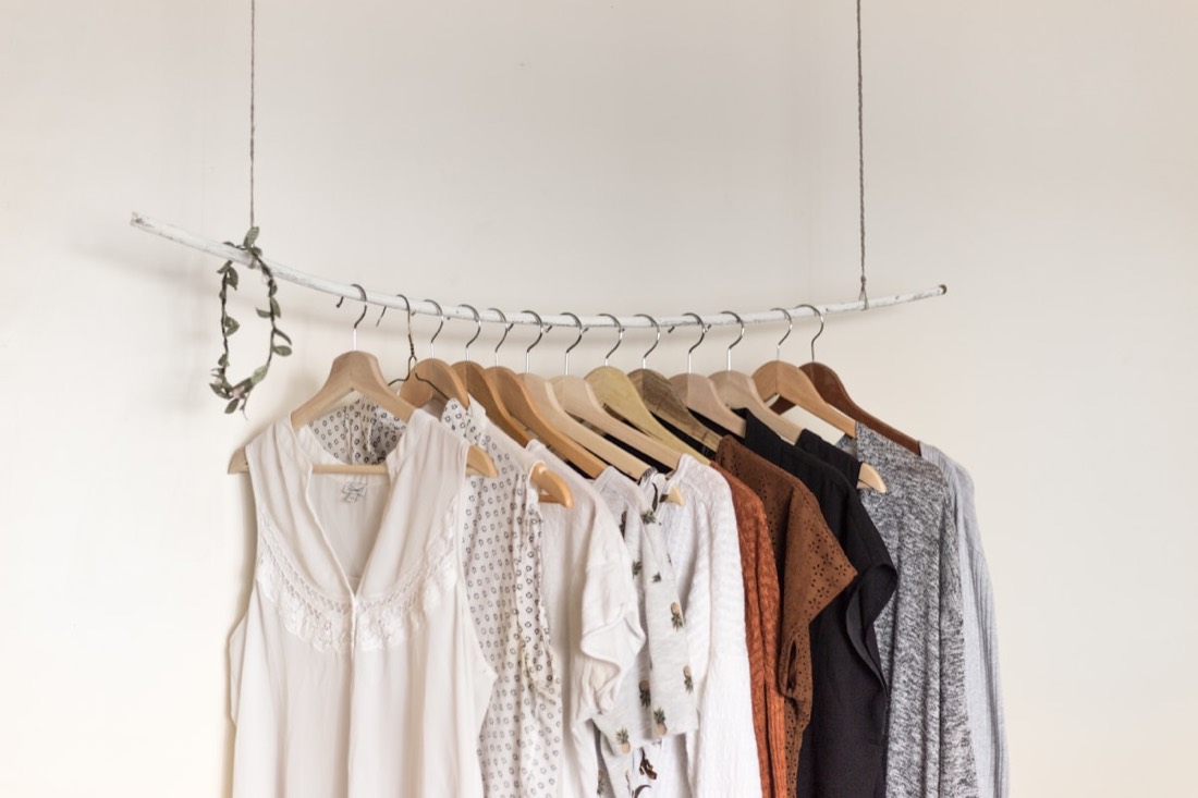 Garments hanging on a rail in soft neutral tones